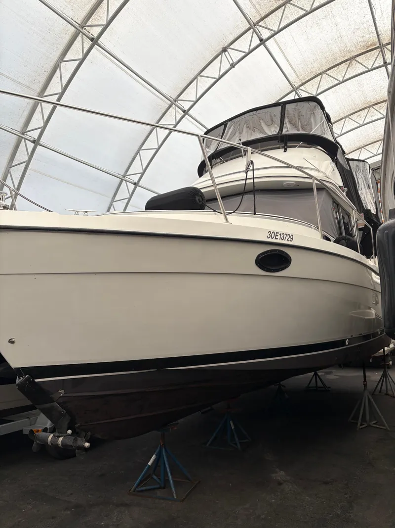 Slide: The Image of 1988 Cooper Prowler boat in storage, under a protective canopy. - 7