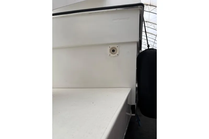 Slide: The Image of 1988 Cooper Prowler boat detail showing white exterior and dock fender. - 75
