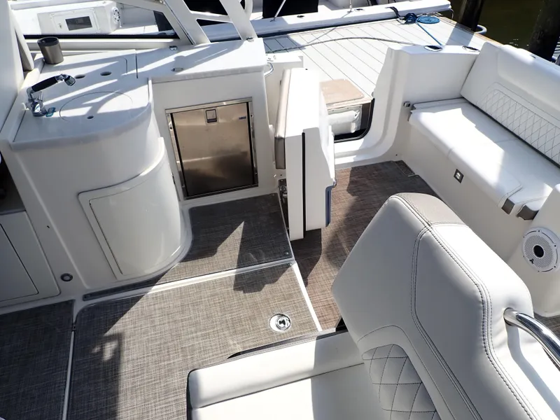 Slide: The Image of 2022 World Cat 325 DC boat interior with seating, sink, and storage. - 10