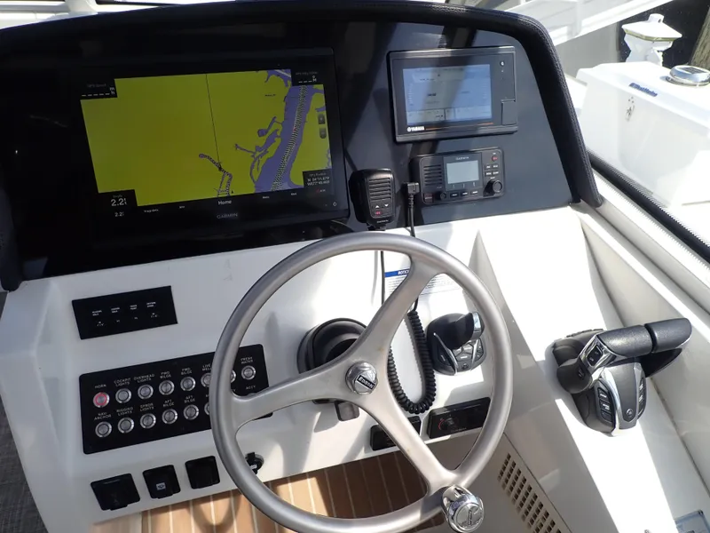 Slide: The Image of Cockpit of 2022 World Cat 325 DC with navigation and control systems. - 13