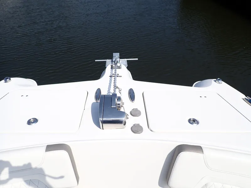 Slide: The Image of Bow of 2022 World Cat 325 DC boat with anchor and storage compartments. - 16