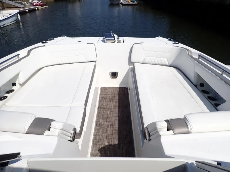 Slide: The Image of 2022 World Cat 325 DC boat interior with white seating and water view. - 17
