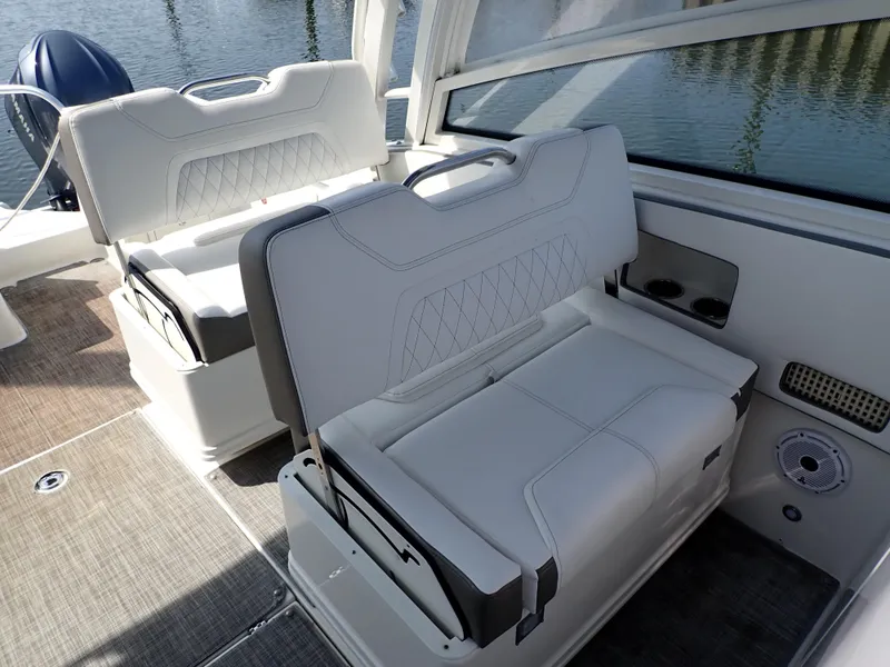 Slide: The Image of 2022 World Cat 325 DC boat interior with white cushioned seating and cup holders. - 18
