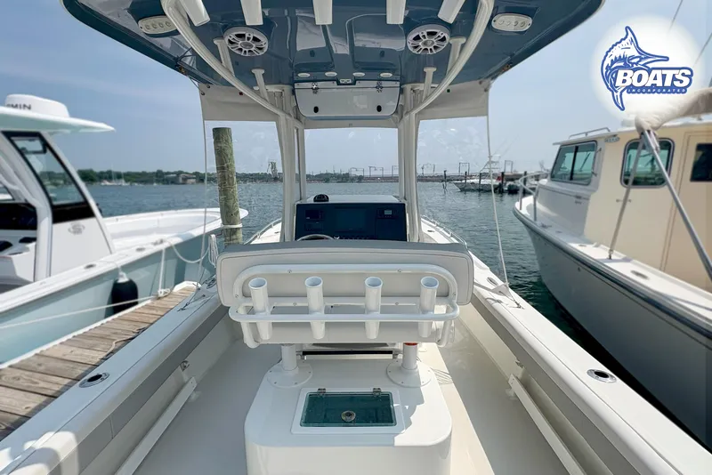 Slide: The Image of 2021 Parker 2300 Center Console boat docked, featuring spacious seating and modern controls. - 11