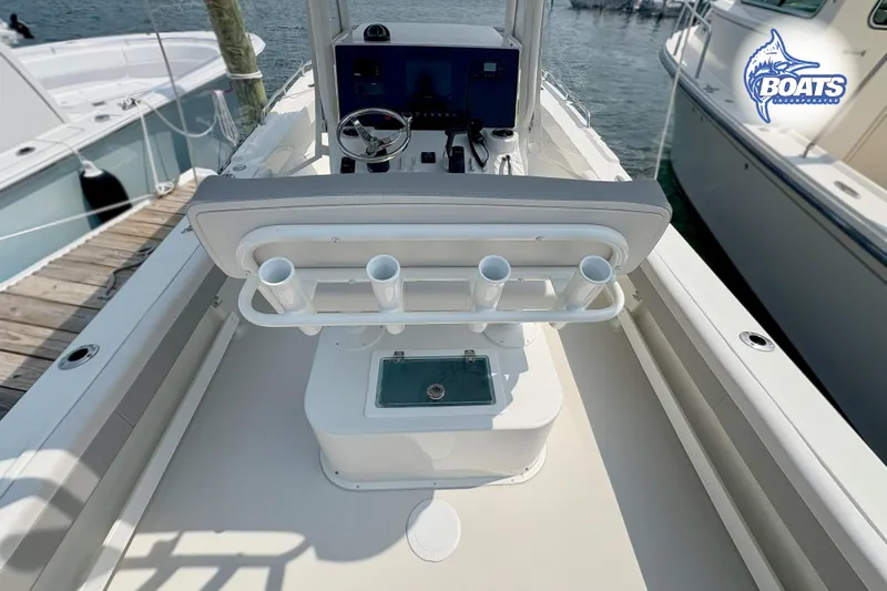 Slide: The Image of 2021 Parker 2300 Center Console boat interior with rod holders and helm station. - 12