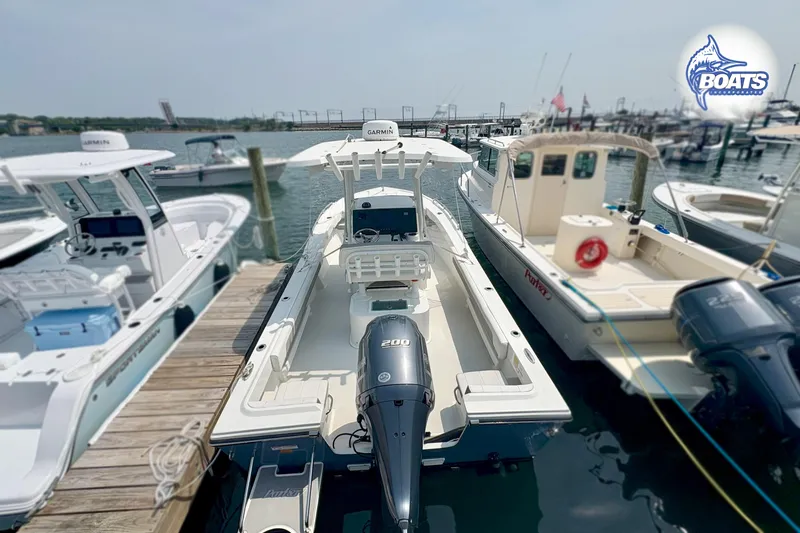 Slide: The Image of 2021 Parker 2300 Center Console boat docked at marina with other vessels. - 13