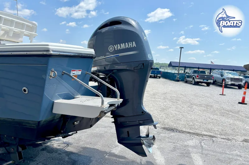 Slide: The Image of 2021 Parker 2300 Center Console boat with Yamaha outboard motor in a parking lot. - 16