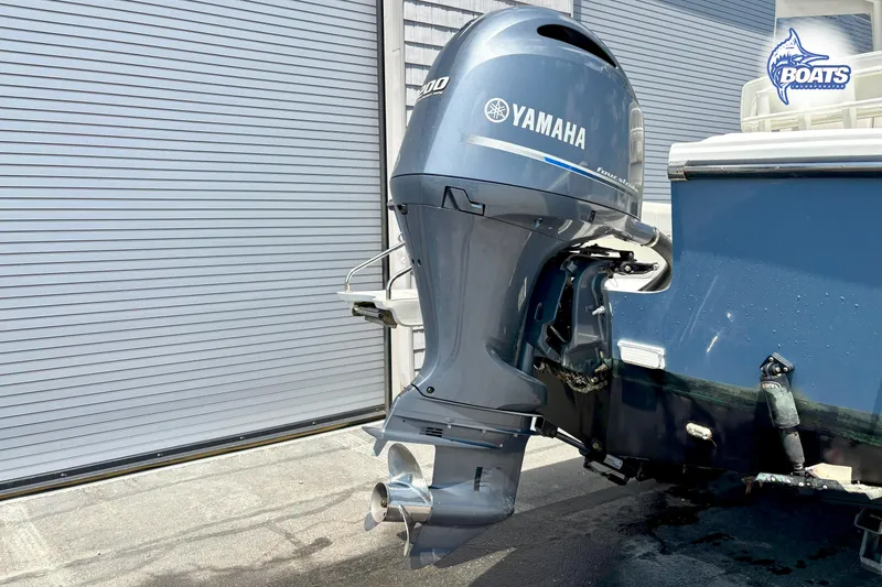 Slide: The Image of Parker 2300 Center Console 2021 with Yamaha outboard motor, parked near a garage door. - 17