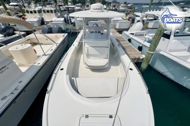 Slide: The Image of 2021 Parker 2300 Center Console boat docked at marina, featuring Garmin equipment. - 3