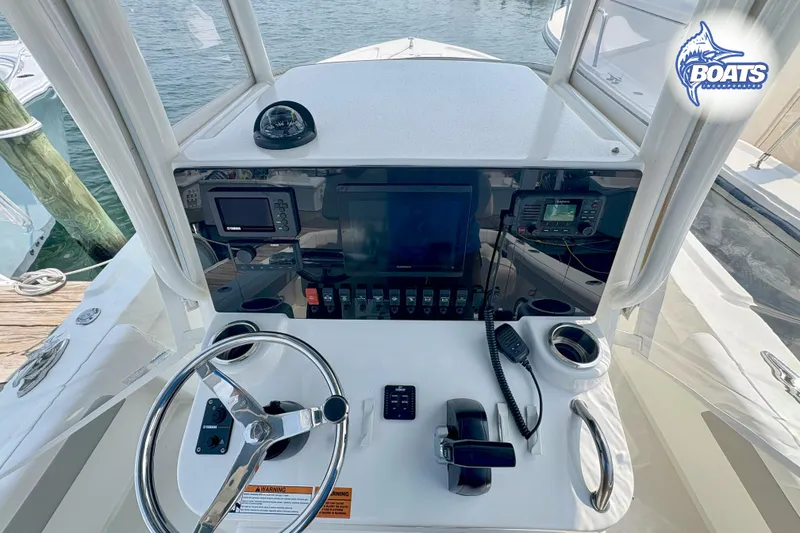 Slide: The Image of Center console of 2021 Parker 2300 boat with steering wheel and navigation equipment. - 9