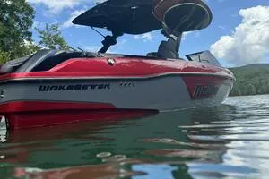 The Image of 2022 Malibu Wakesetter 23 LSV boat on a lake with scenic background. - 0