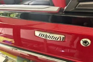 Slide: The Image of 2022 Malibu Wakesetter 23 LSV, red exterior, close-up of logo and detailing. - 12