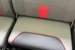 Slide: The Image of 2022 Malibu Wakesetter 23 LSV boat seat with gray and red upholstery. - 20