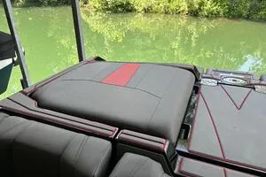 Slide: The Image of 2022 Malibu Wakesetter 23 LSV interior with sleek seating by a green lake. - 29