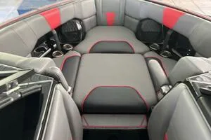 Slide: The Image of 2022 Malibu Wakesetter 23 LSV interior with gray and red seating, cup holders, and speakers. - 31