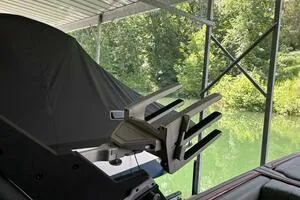 Slide: The Image of 2022 Malibu Wakesetter 23 LSV covered, docked by a serene, green waterway. - 40