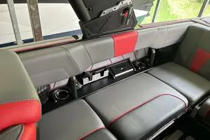 Slide: The Image of 2022 Malibu Wakesetter 23 LSV interior seating with red and gray upholstery. - 47