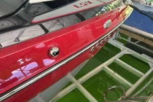 Slide: The Image of 2022 Malibu Wakesetter 23 LSV, red exterior, docked in marina. - 6