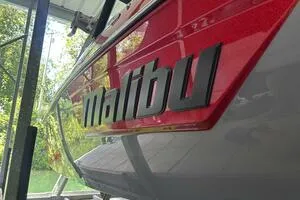 Slide: The Image of 2022 Malibu Wakesetter 23 LSV boat with red and black logo detail. - 7