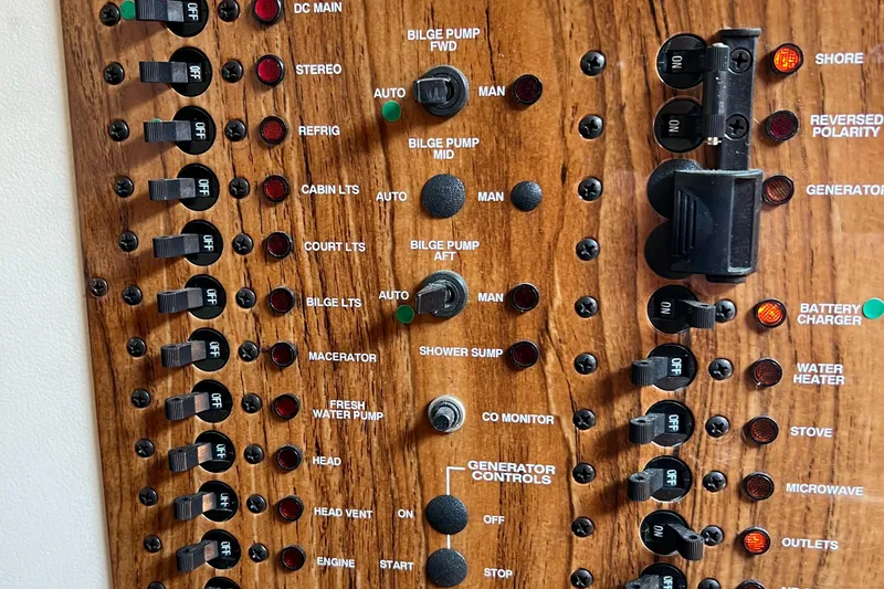 Slide: The Image of Control panel of a 2001 Mainship 34 PILOT boat with various switches and indicators. - 23