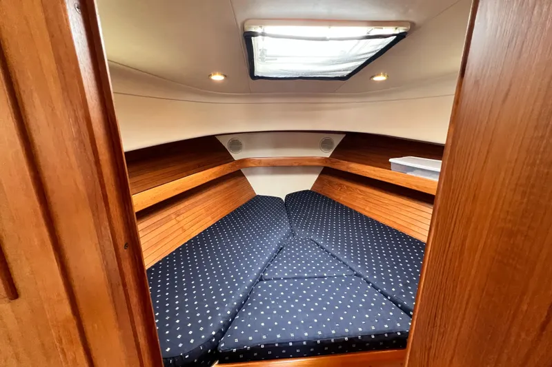Slide: The Image of 2001 Mainship 34 PILOT cabin with cozy V-berth and wooden interior. - 31