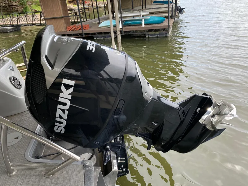 Slide: The Image of Outboard motor on 2022 Manitou 25 LX SRW SHP pontoon boat at dock. - 14
