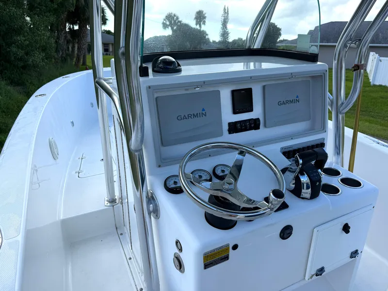 Slide: The Image of 2015 Bluewater 2550 boat console with Garmin navigation system and steering wheel. - 11