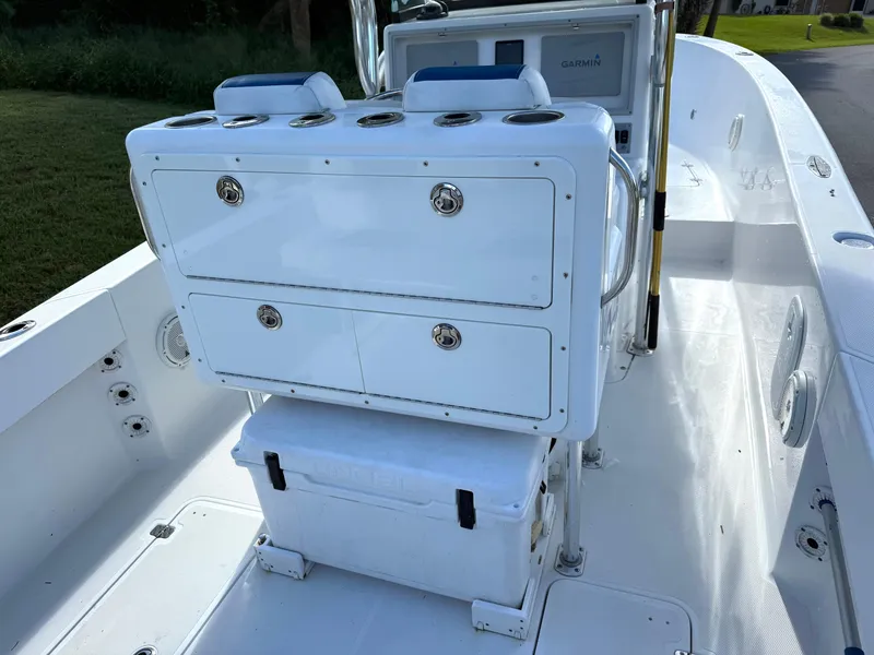 Slide: The Image of 2015 Bluewater 2550 boat interior with storage compartments and cooler. - 12
