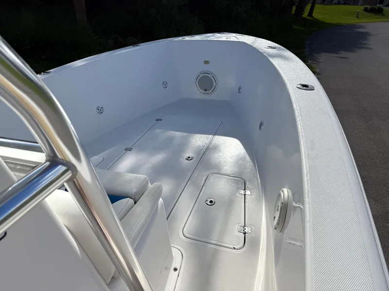 Slide: The Image of 2015 Bluewater 2550 boat interior with white deck and seating. - 7