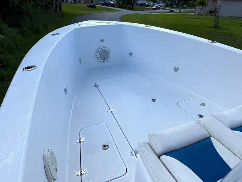 Slide: The Image of 2015 Bluewater 2550 boat interior with white deck and seating. - 8