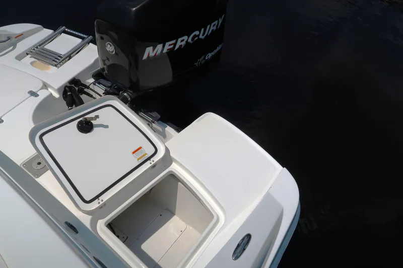 Slide: The Image of 2017 Tahoe 2150 boat with Mercury engine and open storage compartment. - 12