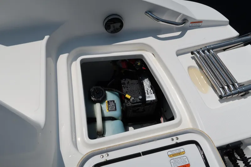 Slide: The Image of 2017 Tahoe 2150 boat battery compartment with ladder and storage area. - 13