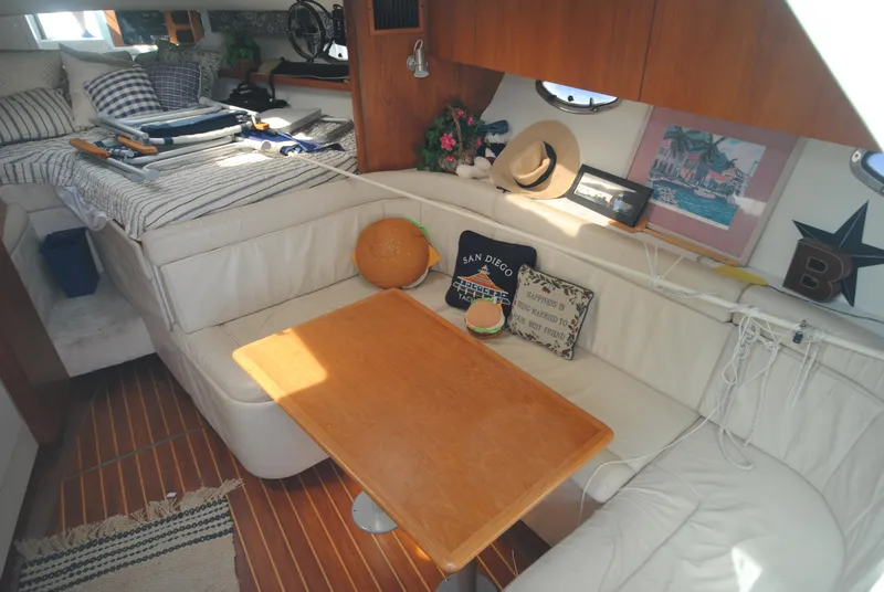 Slide: The Image of Interior of 1996 Tiara Yachts 3100 Open with cozy seating and nautical decor. - 10