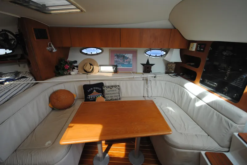 Slide: The Image of Interior of 1996 Tiara Yachts 3100 Open with cozy seating and wooden table. - 12