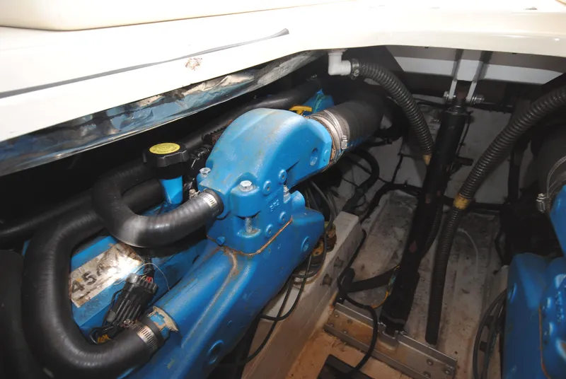 Slide: The Image of Engine compartment of a 1996 Tiara Yachts 3100 Open, showcasing blue engine components. - 17