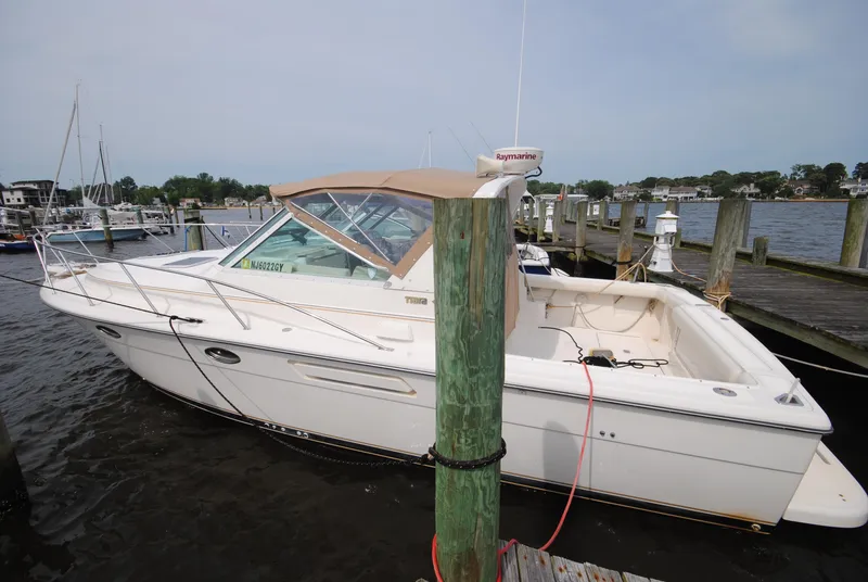 Slide: The Image of 1996 Tiara Yachts 3100 Open docked at marina, side view. - 2