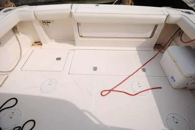 Slide: The Image of 1996 Tiara Yachts 3100 Open deck with storage compartments and cooler. - 4