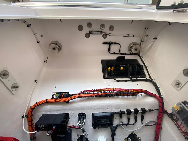 Slide: The Image of Electrical wiring and components inside a 2026 Reef Runner 230 boat. - 17
