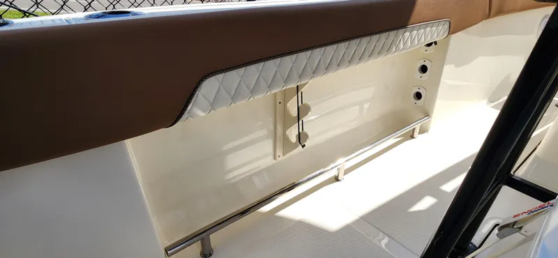 Slide: The Image of 2025 Pioneer 202 Islander boat interior with brown and white seating, stainless steel railing. - 10