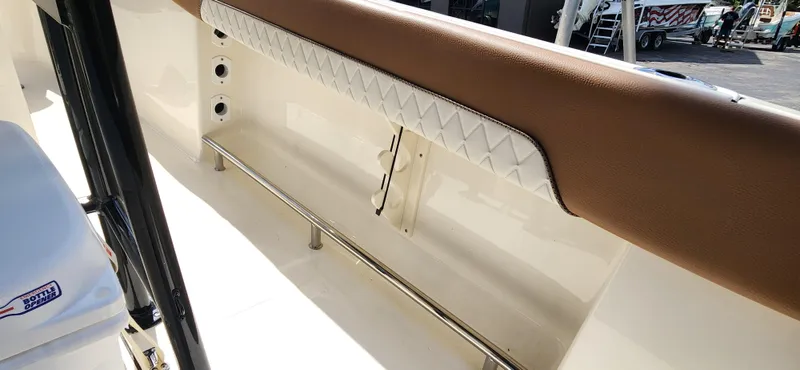 Slide: The Image of 2025 Pioneer 202 Islander boat interior with brown and white cushioned seating. - 11