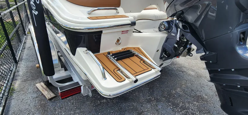 Slide: The Image of 2025 Pioneer 202 Islander boat stern with swim platform and outboard motor. - 2