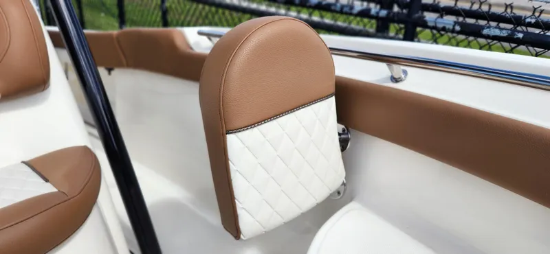 Slide: The Image of 2025 Pioneer 202 Islander boat interior with brown and white cushioned seating detail. - 20