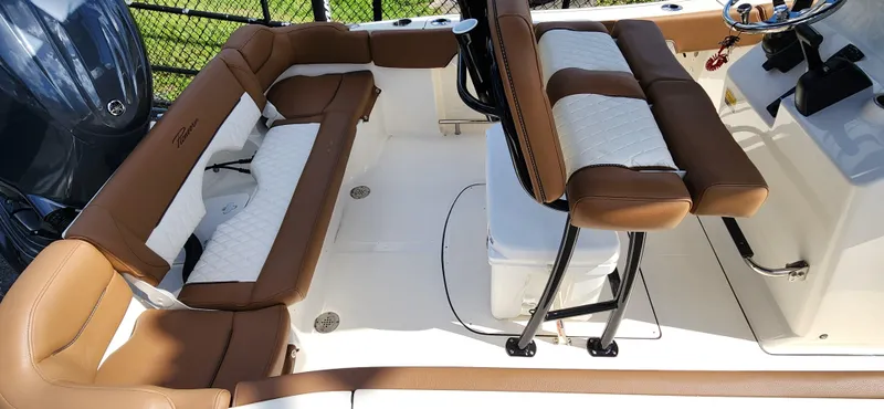 Slide: The Image of 2025 Pioneer 202 Islander boat interior with brown and white seating, steering console, and engine. - 7