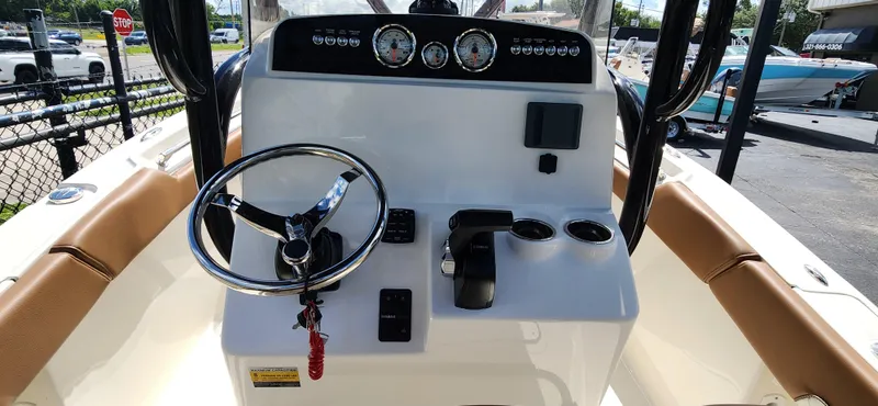 Slide: The Image of 2025 Pioneer 202 Islander boat dashboard with steering wheel and controls. - 9