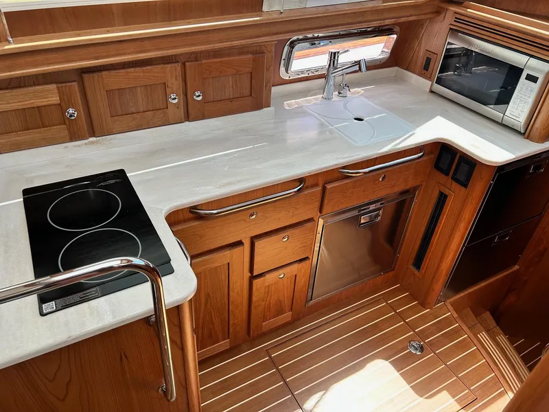 Slide: The Image of Modern kitchen in 2026 Sabre 45 Salon Express yacht with wood cabinetry and appliances. - 10