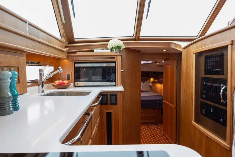 Slide: The Image of Luxurious interior of 2026 Sabre 45 Salon Express yacht with modern kitchen and cozy bedroom. - 11