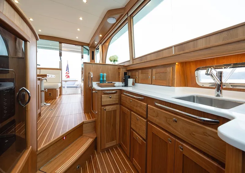 Slide: The Image of Luxurious interior of 2026 Sabre 45 Salon Express yacht with wooden cabinetry and modern amenities. - 12