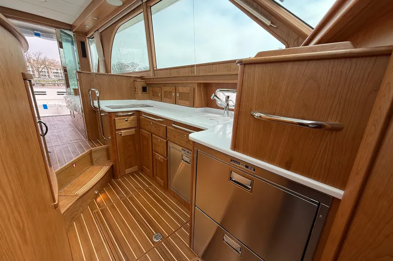 Slide: The Image of Luxurious interior of 2026 Sabre 45 Salon Express yacht with wooden cabinetry and modern appliances. - 21