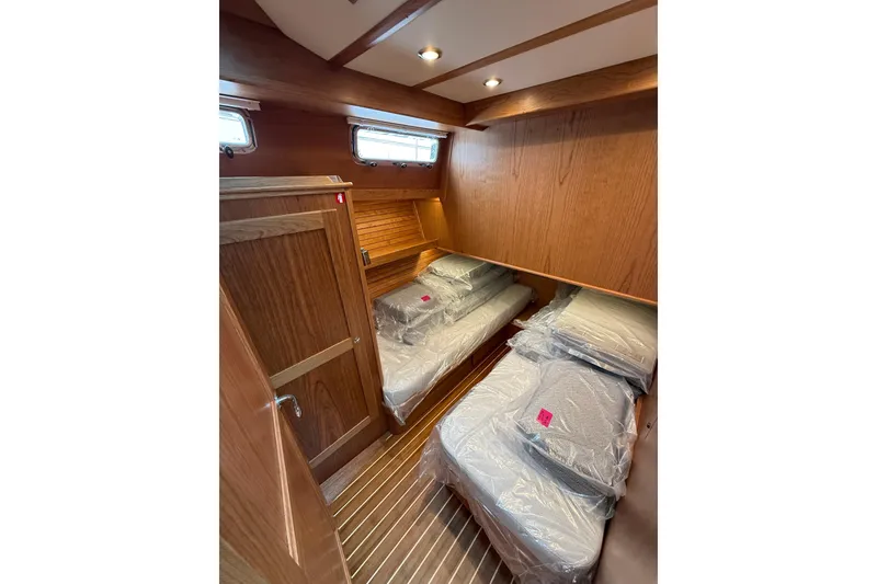 Slide: The Image of Interior cabin of 2026 Sabre 45 Salon Express with wooden finishes and twin beds. - 23