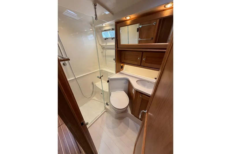 Slide: The Image of Luxurious bathroom in 2026 Sabre 45 Salon Express yacht with modern fixtures and wood accents. - 24